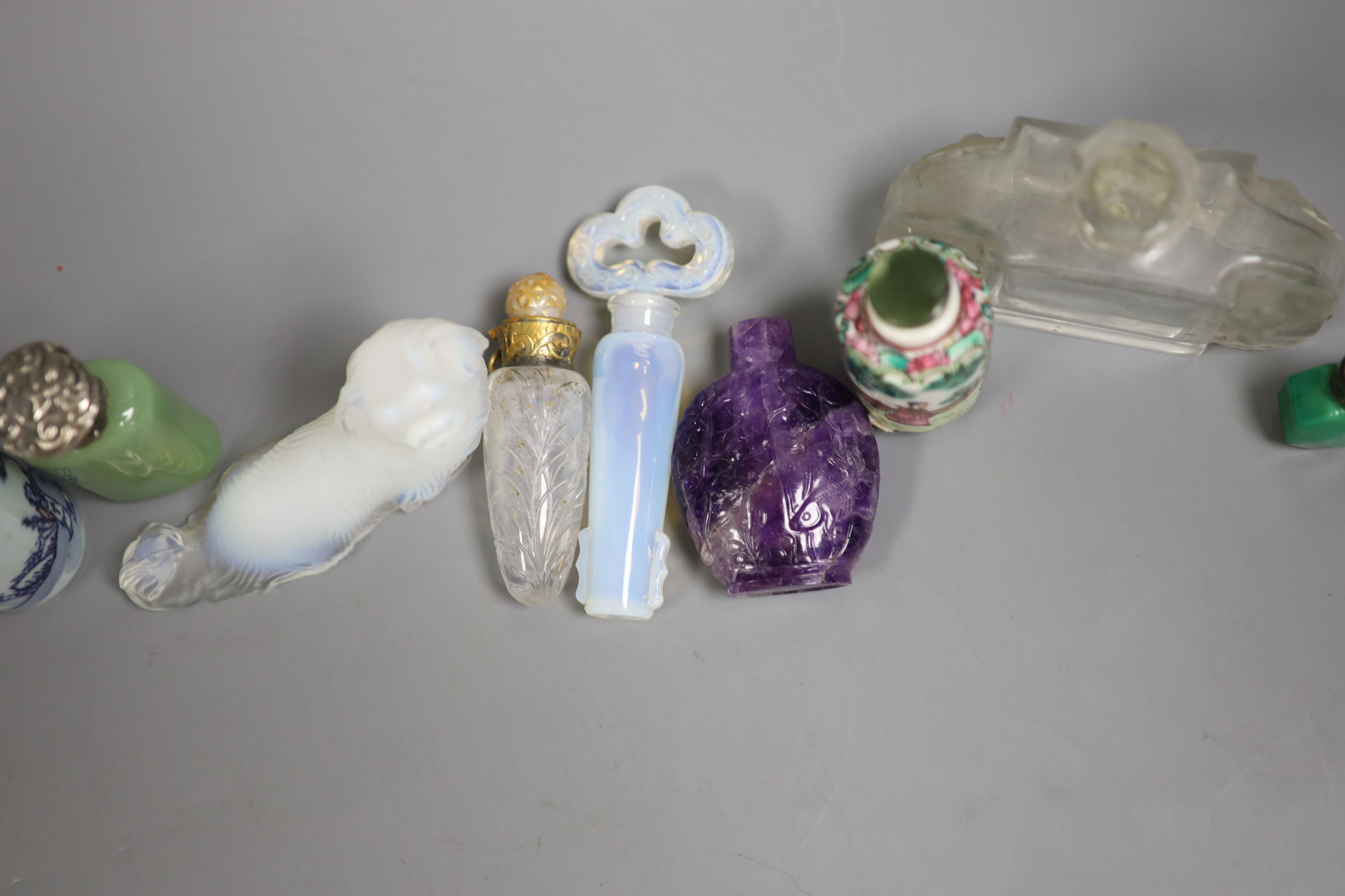 A collection of Chinese snuff bottles and European glass scent bottles, an opalescent glass figure of a dog etc.